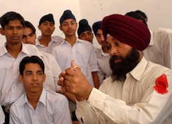 An adolescent peer volunteer demonstrates correct condom use to the students of Government Sr.Sec.School, Khuda Lahora, Chandigarh, India, under the Adolescent Development and Empowerment Project run by the Ministry of Sports and Youth Welfare, Government of India. © 2007 Pradeep Tewari, Courtesy of Photoshare